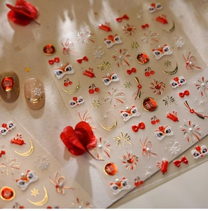 Detail of Lunar New Year nail stickers with gold Fu character and lion dance motifs