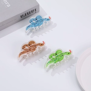 Three glittery snake-shaped hair claws in blue, brown and green acrylic for stylish updos