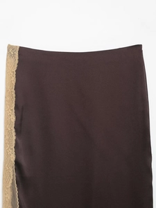 Detailed close-up of dark chocolate satin fabric with elegant beige lace trim edges