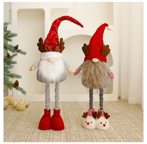 Close-up of plush Christmas gnomes with sequined red hats on a woven rug