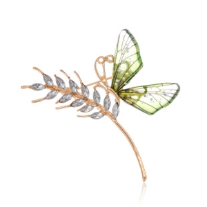 Detailed view of butterfly brooch with green wings and golden wheat stalk with crystals