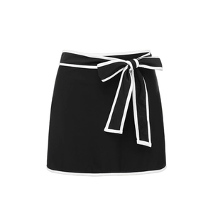 Detail of black bikini bottom with large white contrast bow and elegant white piping