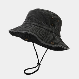 Detail view of the metal air vents and adjustable chin strap on the sun hat