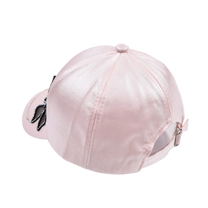 Detail of pink satin baseball cap with rhinestone butterfly decoration on the brim