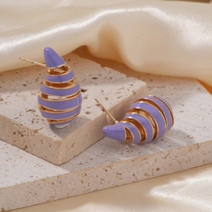 Elegant gold and purple spiral water drop earrings displayed on a textured stone surface