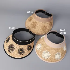 Detailed view of sun hats in black, coffee, and beige with floral embroidery