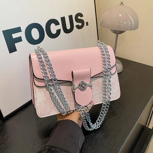 Elegant pink chain crossbody bag with floral texture and silver hardware details.