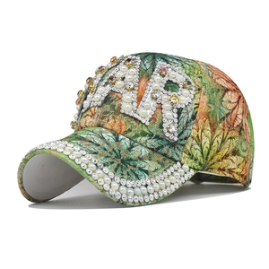 Detailed view of the tropical print baseball cap with AIR rhinestone and pearl embellishments
