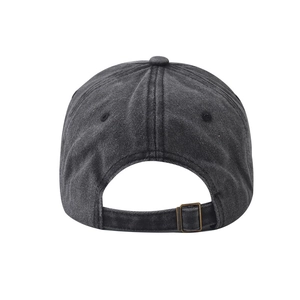 Detail view of washed cotton baseball cap featuring adjustable bronze metal buckle and stitching