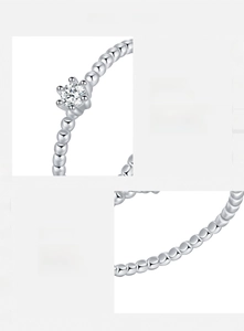 Macro detail of round moissanite D VVS1 3EX on s925 silver beaded band ring