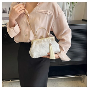 Detailed lace flower embroidery on white evening clutch bag with metal ring handle