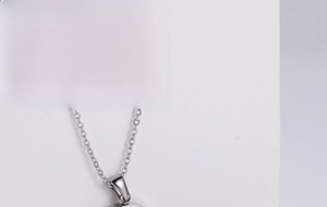 Three-piece minimalist silver steel jewelry set featuring spherical beads and pendant