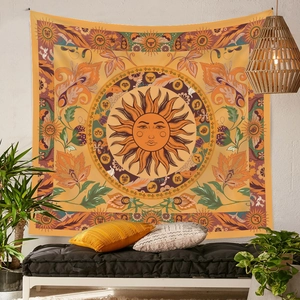 Macro detail of Bohemian sun mandala tapestry with zodiac symbols and orange floral patterns