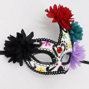 Detail of Day of the Dead mask with colorful floral decorations and sparkly rhinestones