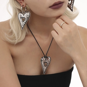 Polished silver heart jewelry set with textured earrings and black cord necklace