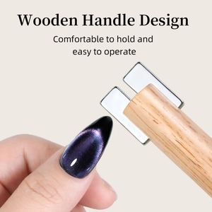 Detail of wooden handle nail magnet tool creating wide cat eye effect on purple nails