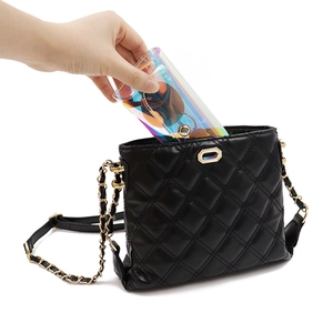 Putting a colorful laser PVC sunglasses case into a black quilted chain shoulder bag