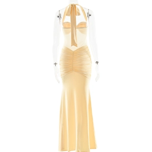 Detail of light yellow backless halter dress with ruched texture and fishtail hem