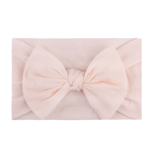 Soft nylon infant headband featuring a sweet light pink oversized decorative bow