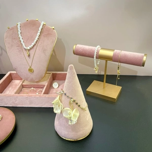 Luxury jewelry storage stand displaying gold necklaces, pearl bracelets and earrings