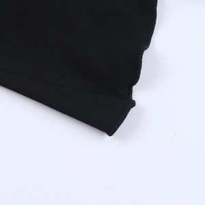 Detail of fine black knit fabric showing high-density stitching and edge locking finish