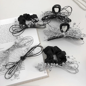 Elegant black hair accessories set with silver chain and beads on white background
