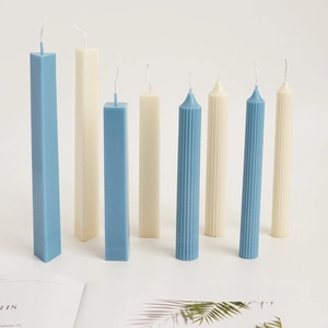 Blue and beige vertical stripe aromatherapy candles in long rectangular pillar shapes