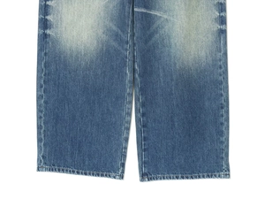 Close-up of rolled hem detail and heavy-duty washed denim texture on loose jeans