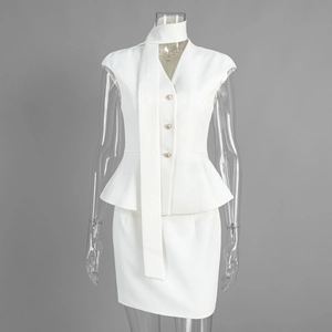 Detail of white peplum vest with gold buttons and matching mini skirt on model