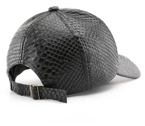 Detail of adjustable metal buckle and snake-embossed faux leather on black baseball cap