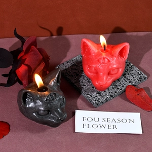 Three-eyed cat scented candle with gothic design for Halloween decor in red and black