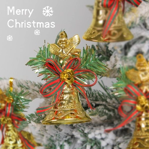 Golden Christmas bell ornament with angel figure and red-green bow on a snowy tree