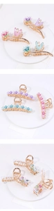 Detail of alloy flower hair claws with enamel wings, pearls and crystal accents