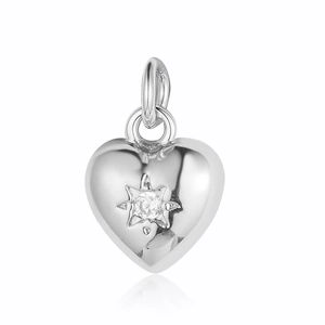 Macro detail of silver heart pendant with star-set cubic zirconia and polished finish