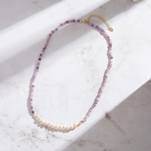 Detail of purple natural stone and freshwater pearl beaded necklace with gold S925 clasp