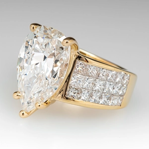 Elegant gold pear cut zircon ring with micro-paved square diamond band on white surface