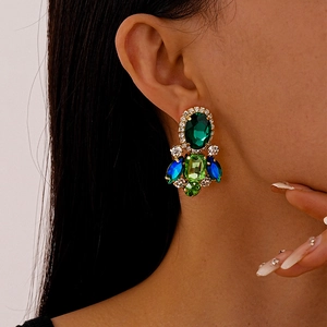 Detail of luxury vintage earrings with colorful crystals and rhinestones on model