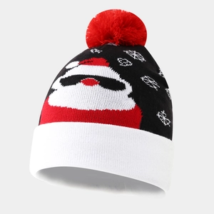 Detailed view of winter knit beanie with Santa Claus wearing sunglasses and pom-pom