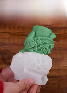 Detailed view of flexible silicone mold showing easy release of 3D rose relief flower candle