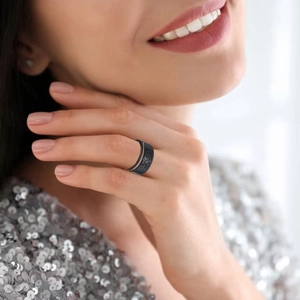 Close-up of black hammered texture adjustable titanium ring on model's finger