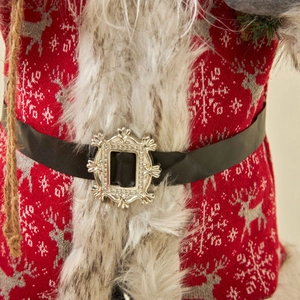 Detailed view of Christmas doll featuring red elk knit fabric and fur trim
