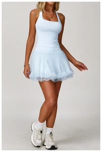 Close-up of light blue yoga dress featuring racerback design and tiered mesh tutu skirt