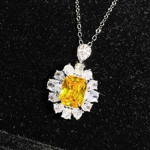 Detailed macro view of floral pendant with square yellow stone and white gemstones