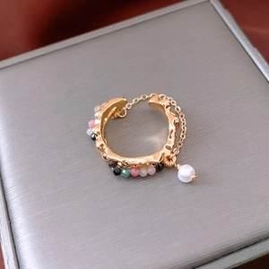 Detailed macro of 18k gold plated cuff earring with multicolor beads and pearl drop charm