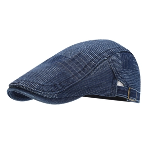 Navy blue denim patchwork beret flat cap with textured pattern and bronze side buckle
