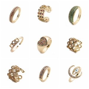 Set of gold rings with colorful cubic zirconia featuring heart and evil eye designs