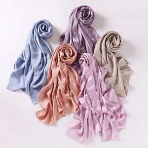 Elegant chiffon silk scarves in pastel shades of blue, pink, and gold displayed in petal shape