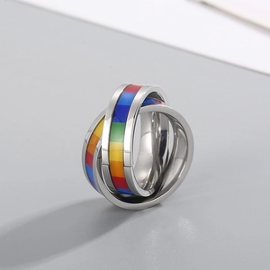 Detail of interlocking silver rings with vibrant colorful square pattern inlay