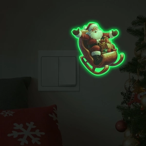 Luminous Santa Claus on sleigh wall sticker showing green glow effect on wall switch