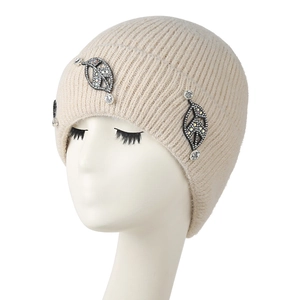 Detailed view of rhinestone leaf patches on beige ribbed knit winter beanie for women